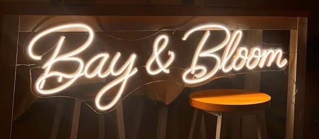 The glowing Bay & Bloom neon sign